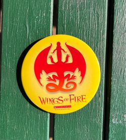 Brand new Scholastic Wings of Fire button, red dragon