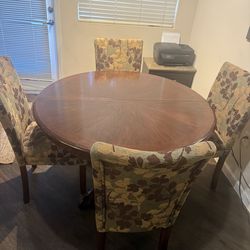 Dining table with four chairs and a leaf