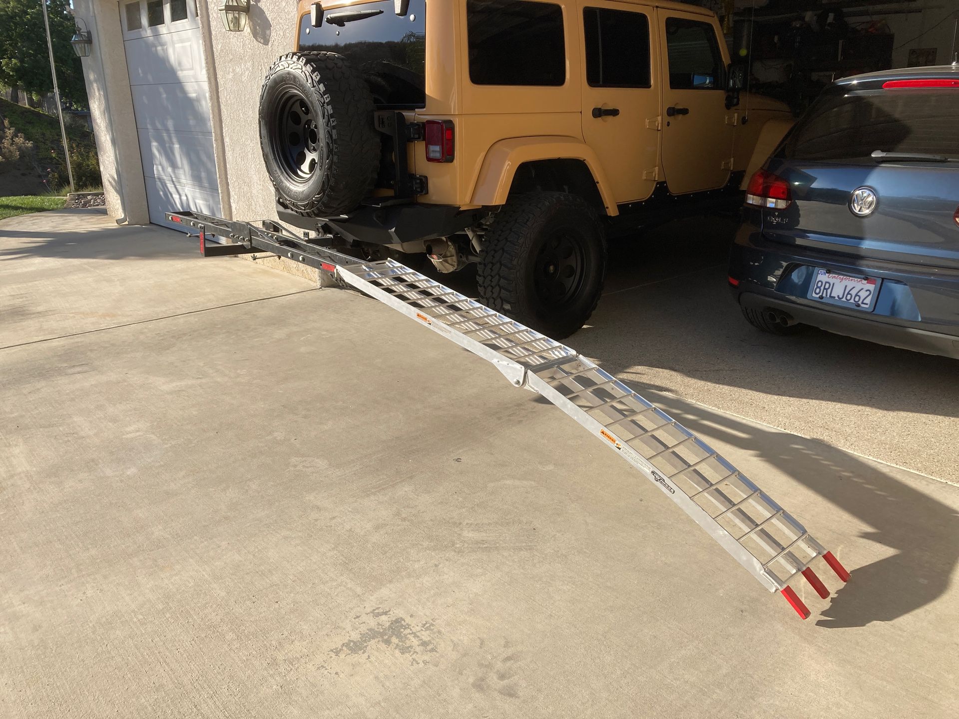 Motorcycle carrier with folding aluminum ramp