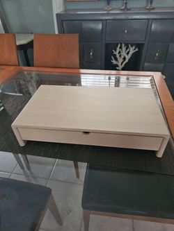 Laptop/monitor stand made of natural wood.