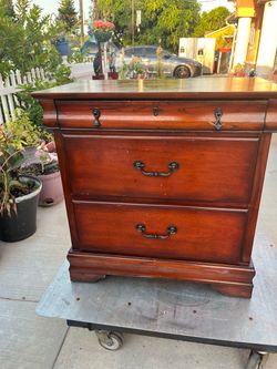 Hardwood 3-drawer nightstand in good, very clean condition; measures 28 inches high, 27 3/4 inches wide, and 17 inches deep