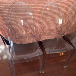 4 clear plastic chairs