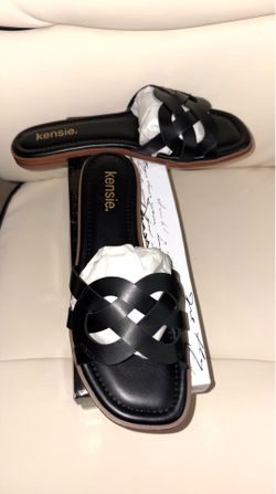 Kensie brand flat sandals feature a black braided design and a square toe.