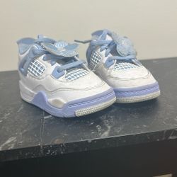 Toddler-sized Air Jordan 4 Retro sneakers.