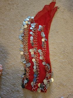 red belly dance hip scarf features a triangle shape adorned with numerous silver-toned coins.