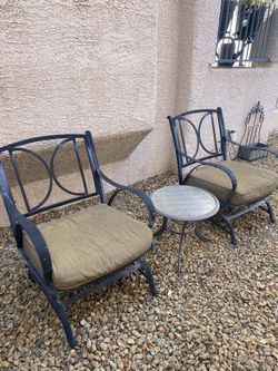 Two chairs  outside doors with coffee table 