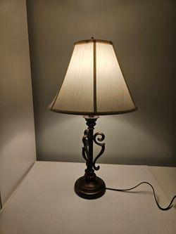 Traditional bronze scross table lamp with cream shade