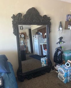 83“ x 45“This ornate, black floor mirror resembles Louis XV-style designs with a carved resin 83” x 45”