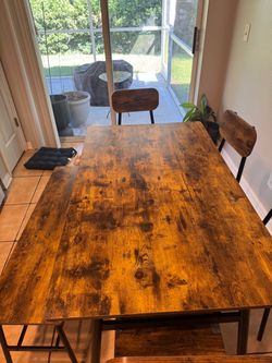 Wood table with four chairs and one bench