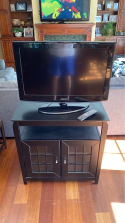 Samsung TV and a Tech Craft solid wood stand.