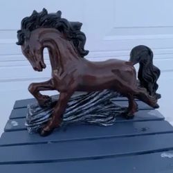 Horse Jumping Over Log Statue