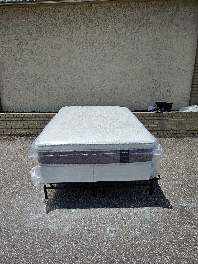 Brand new full size plush pillow top mattress and box spring in plastics