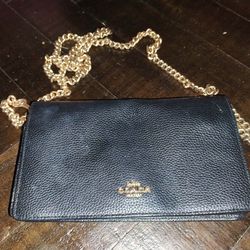 Coach black pebbled leather wallet-on-chain / slim crossbody (very common outlet style).