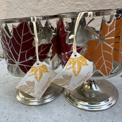 New! Set of two metal candle holders with autumn leaf design.