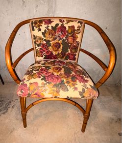 Vintage Rattan Barrel Chair with Floral Upholstery.