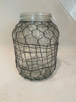 Glass vase with black chicken wire