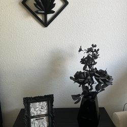 vase, flowers, picture frame, and wall crystals. 