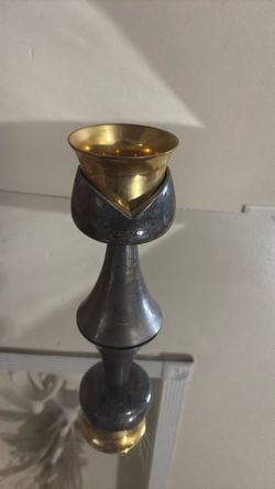 Brass and dark metal chalice-style candle holder