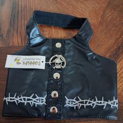 Doggles Biker Vest Dog Harness in black faux leather with embroidered barbed wire details and a skull and crossbone charm. 