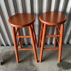 2 burnt orange stools