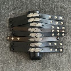 Adjustable leather button bracelet with feathers