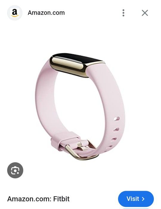 Fitbit Luxe fitness and wellness tracker in a light pink or peony color with a gold-tone stainless steel casing.