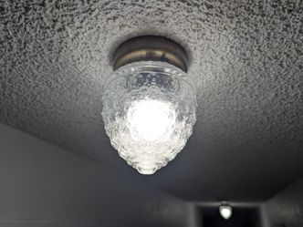 Acorn light fixture with glass globe