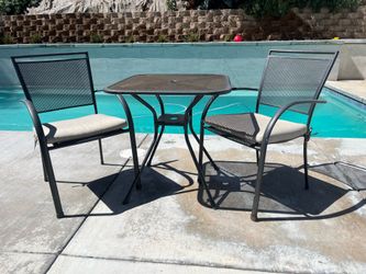 Outdoor table and chairs with cushions