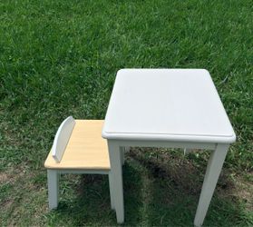 Selling a white kids’ table and chair set.