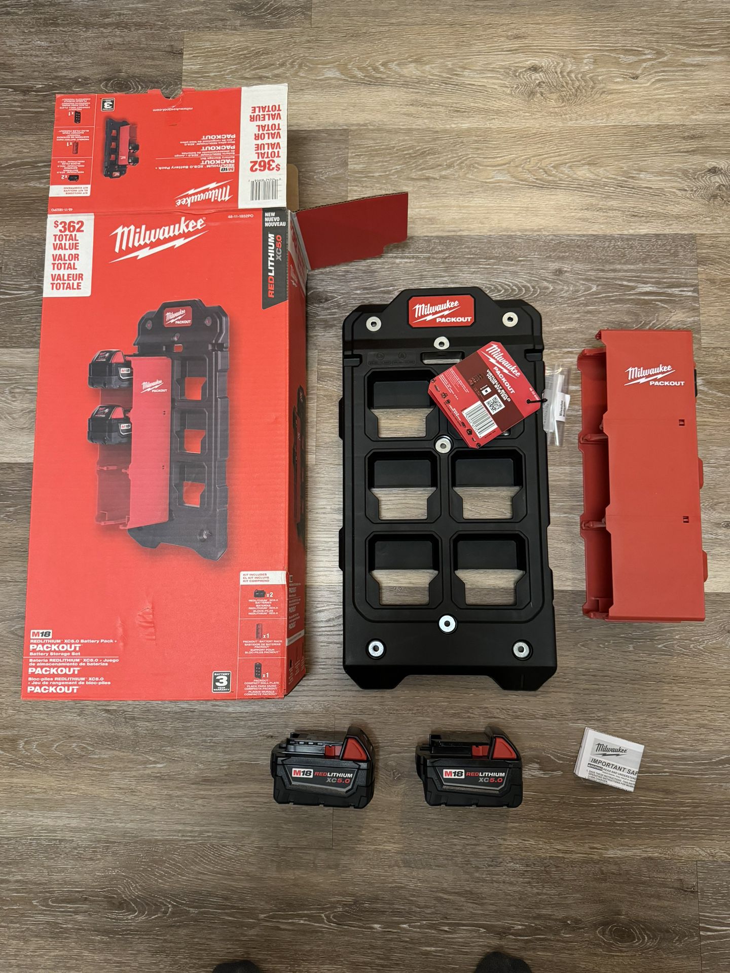 Milwaukee M18 2 pk XC 5.0 AH batteries w packout wall plate. Brand new in box. Never used