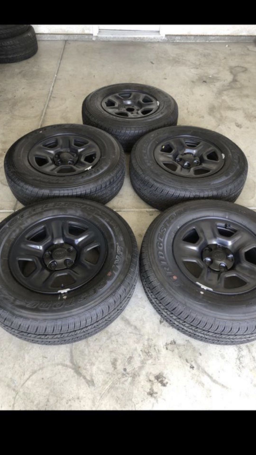 Brand new factory Jeep Wrangler set of five 17 inch wheels and tires with a Bridgestone dueler 245/75/17