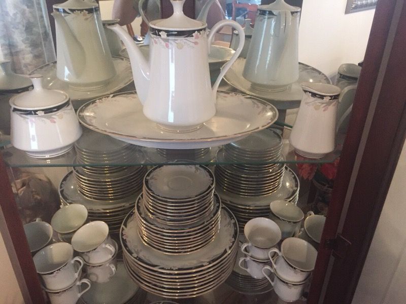Tienshan Fine China service for 8. Pattern is Michelle, white with black border, gold trim with tulips, daffodils and Lily of the Valley.