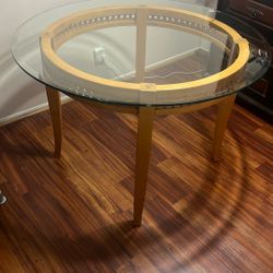 Round wood and glass top dining table.