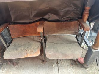 Two wooden auditorium chairs. From a local high school school.
