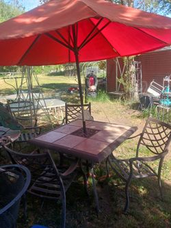 Patio table with four chairs and umbrella