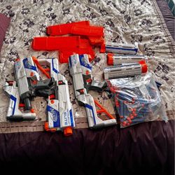 A Lot Of Three Nerf Blasters With Extra Darts