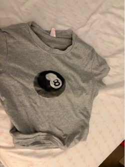 Gray top with a eight ball on it
