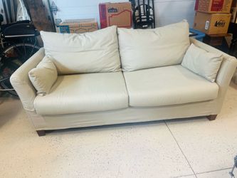 Beige fabric sofa with loose cushions ( back as well)