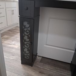 Behind toilet cabinet