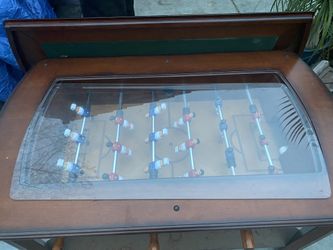 foosball coffee table with a glass top.