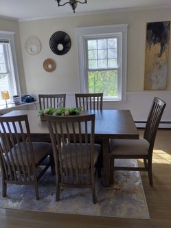 Brand new tan dining table with 8 chairs including leaf.