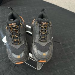 Black and Orange Balenciaga triple s, size: 38 used but still look new.