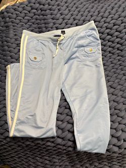 Light blue woman’s athletic pants with white contrast side trim.