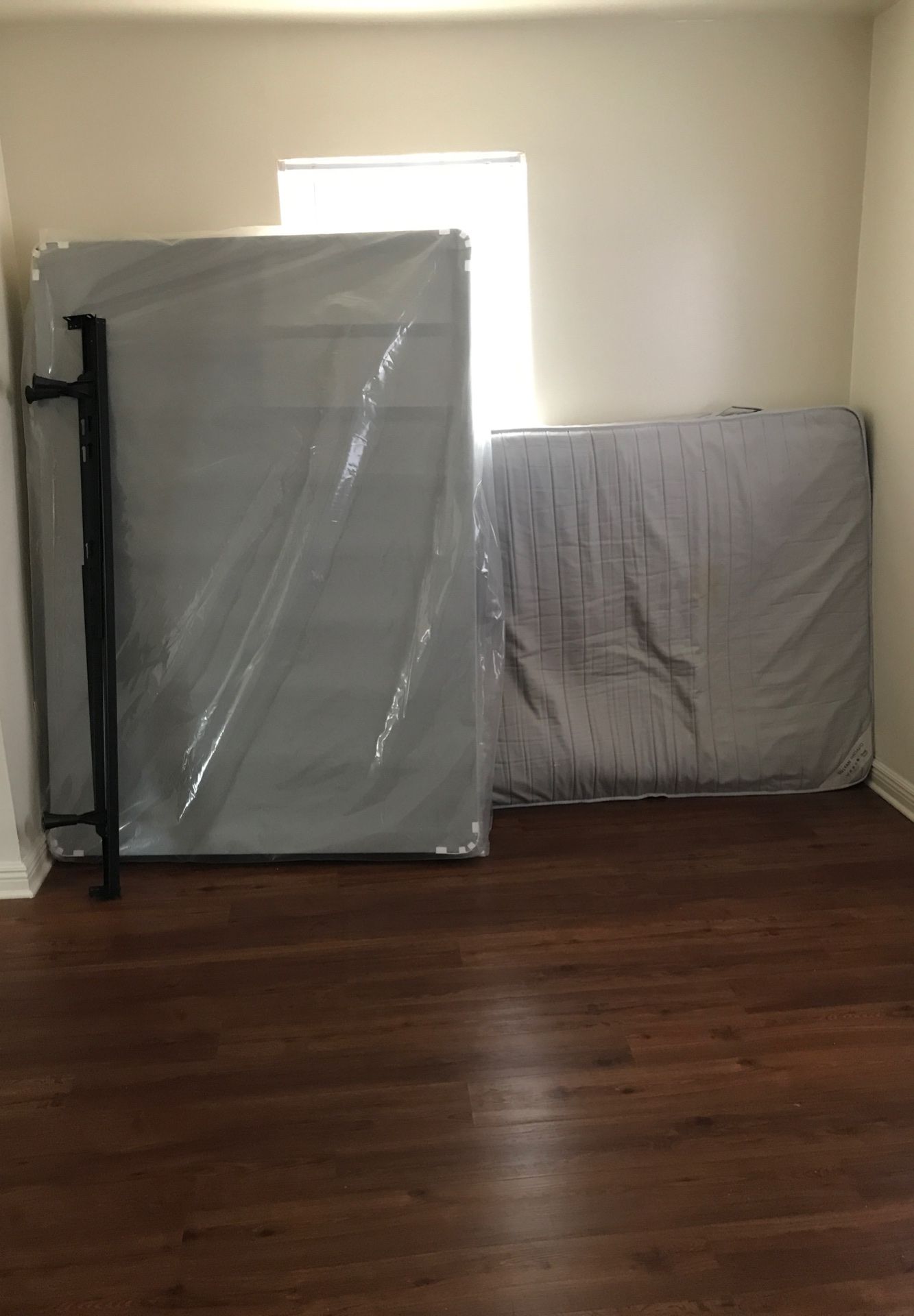 Full size mattress and box spring in a four-door dresser