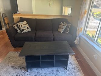 Brown couch w/pillows and ottoman