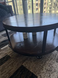 Round wooden coffee table with lower shelf