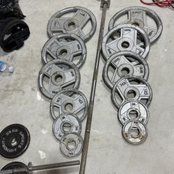 290 LB Olympic Weight Set + 45 LB Barbell – $200