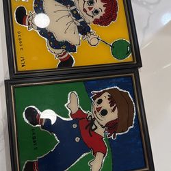 pair vintage paintings Raggedy Ann and Andy, foil art or reverse glass 1976