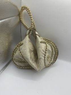 Vintage gold, clamshell, fortune cookie style purse, heavy material very nice bought in Dubai