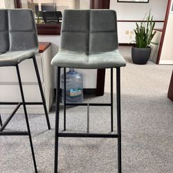 Set of 4 Blu Dot “Between Us” bar stools in the discontinued grey suede upholstery. 